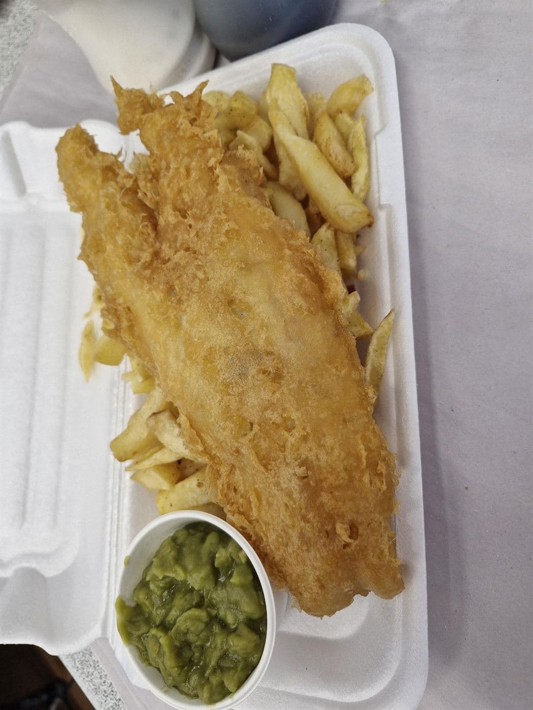Battered fish with chips and mushy peas
